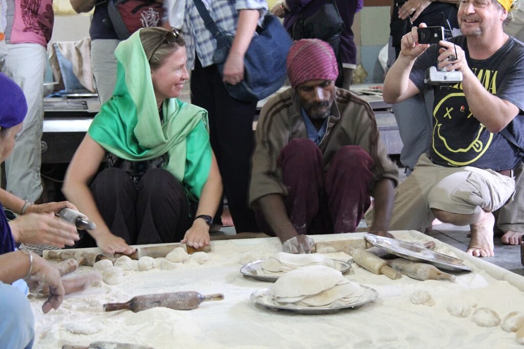 Volunteers making rotis in the langar kitchen at Gurudwara Sis Ganj Sahib on the Old Delhi food walk